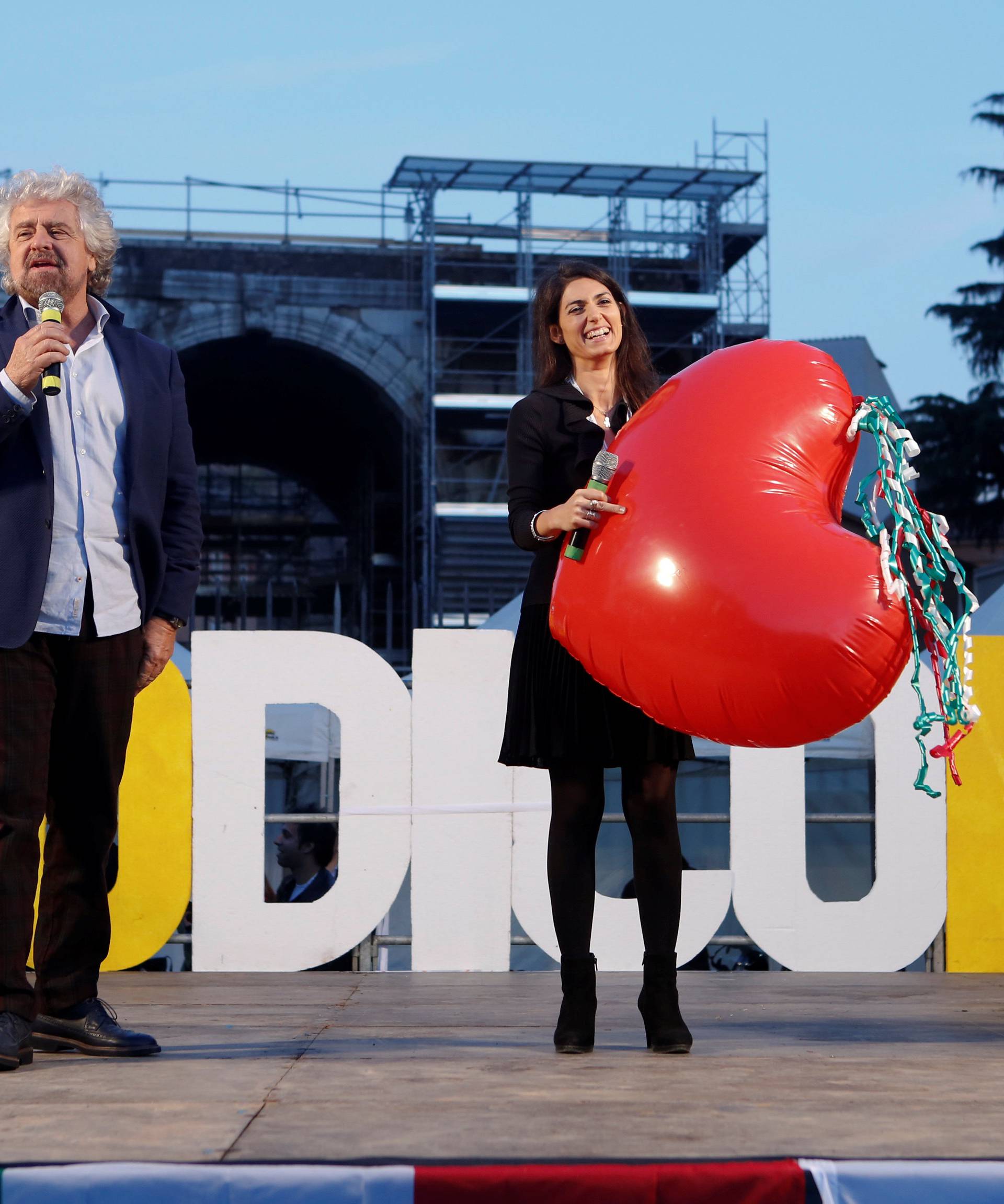 Beppe Grillo, the founder of the anti-establishment 5-Star Movement, stands next to with Rome's Mayor Virginia Raggi during a march in support of the 'No' vote in the upcoming constitutional reform referendum in Rome