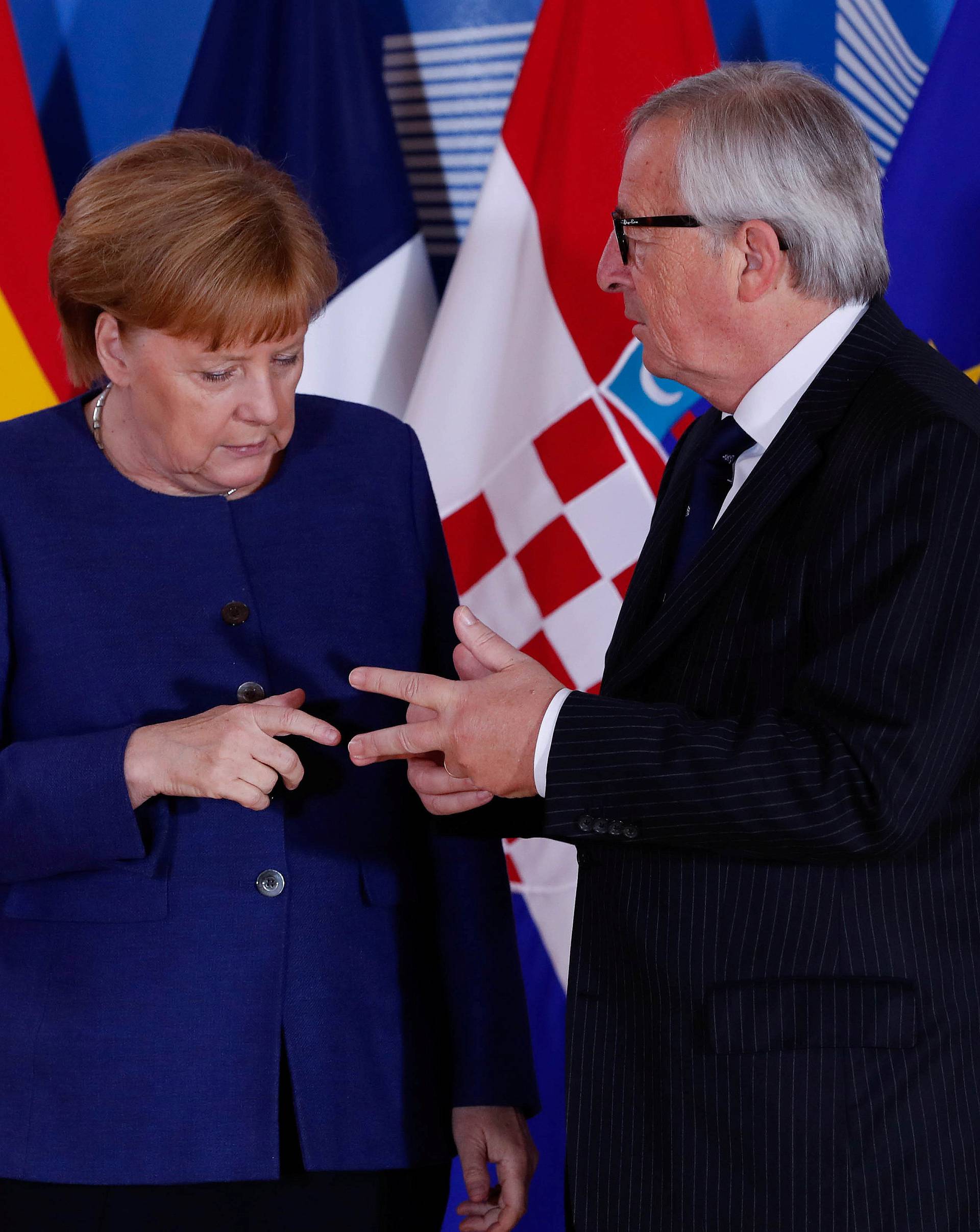 German Chancellor Angela Merkel is welcomed by European Commission President Jean-Claude Juncker at the start of an emergency European Union leaders summit on immigration at the EU Commission headquarters in Brussels