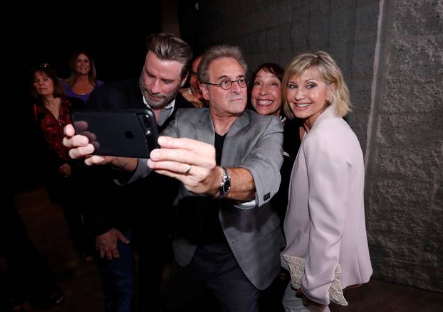 Cast members Travolta, Pearl, Conn and Newton-John pretend to look away as they pose for a selfie at a 40th anniversary screening of "Grease" at the Academy of Motion Picture Arts and Sciences in Beverly Hills