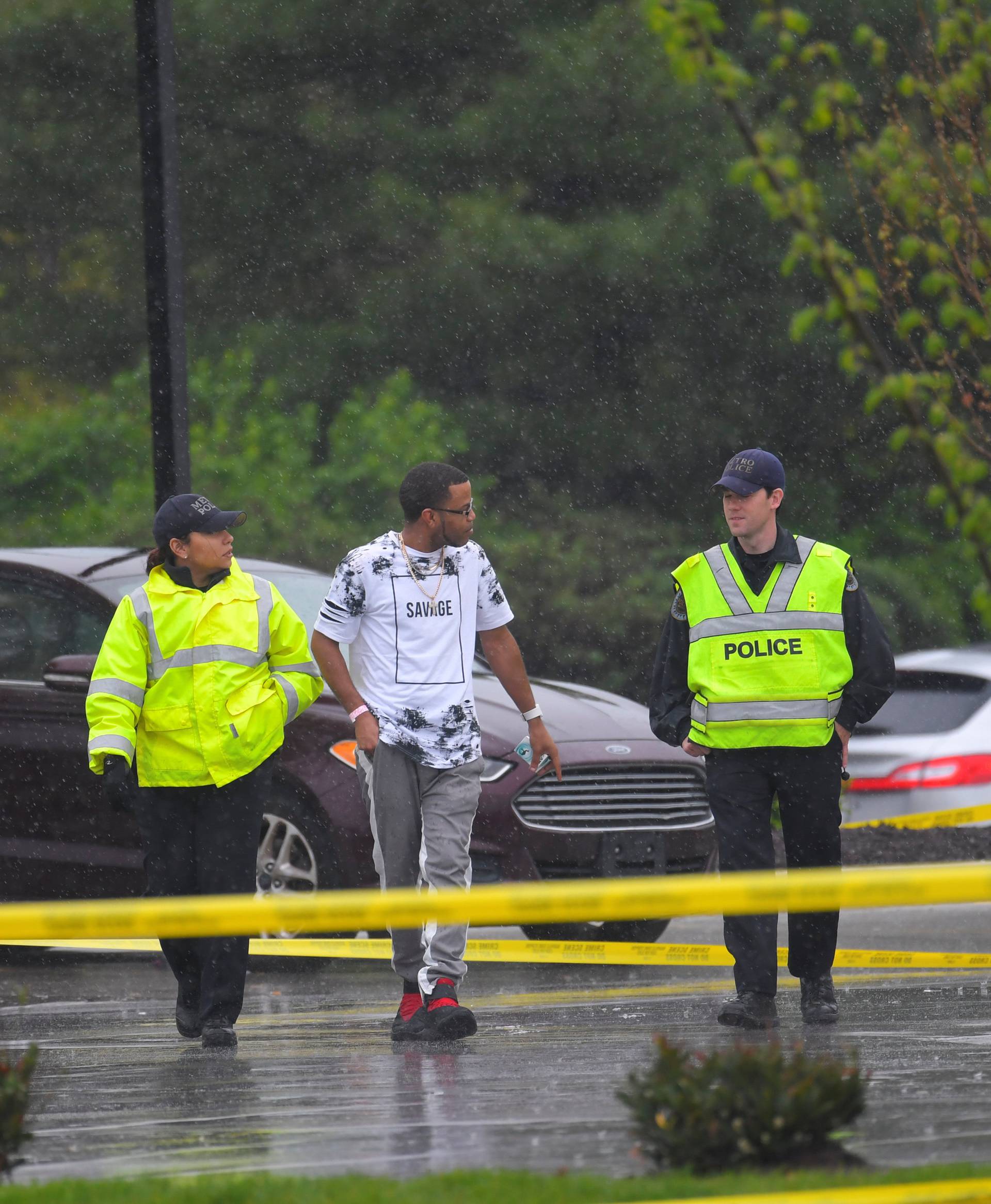 Metro Davidson County Police escort a man to his car at the scene of a fatal shooting at a Waffle House restaurant near Nashville, Tennessee
