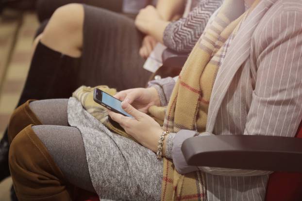 Businesspeople during business conference in conference room or hall