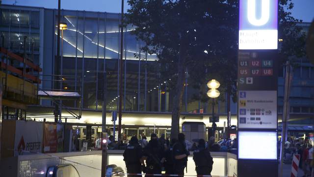 Special force police officers stand guard at entrance of main train station following shooting rampage at shopping mall in Munich