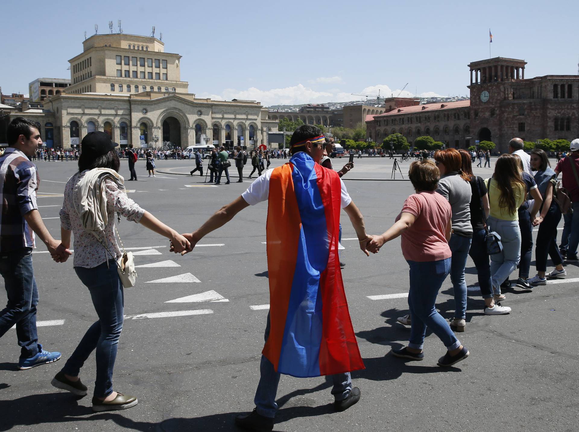 Armenian opposition supporters hold hands in Republic Square after protest movement leader Nikol Pashinyan announced a nationwide campaign of civil disobedience in Yerevan