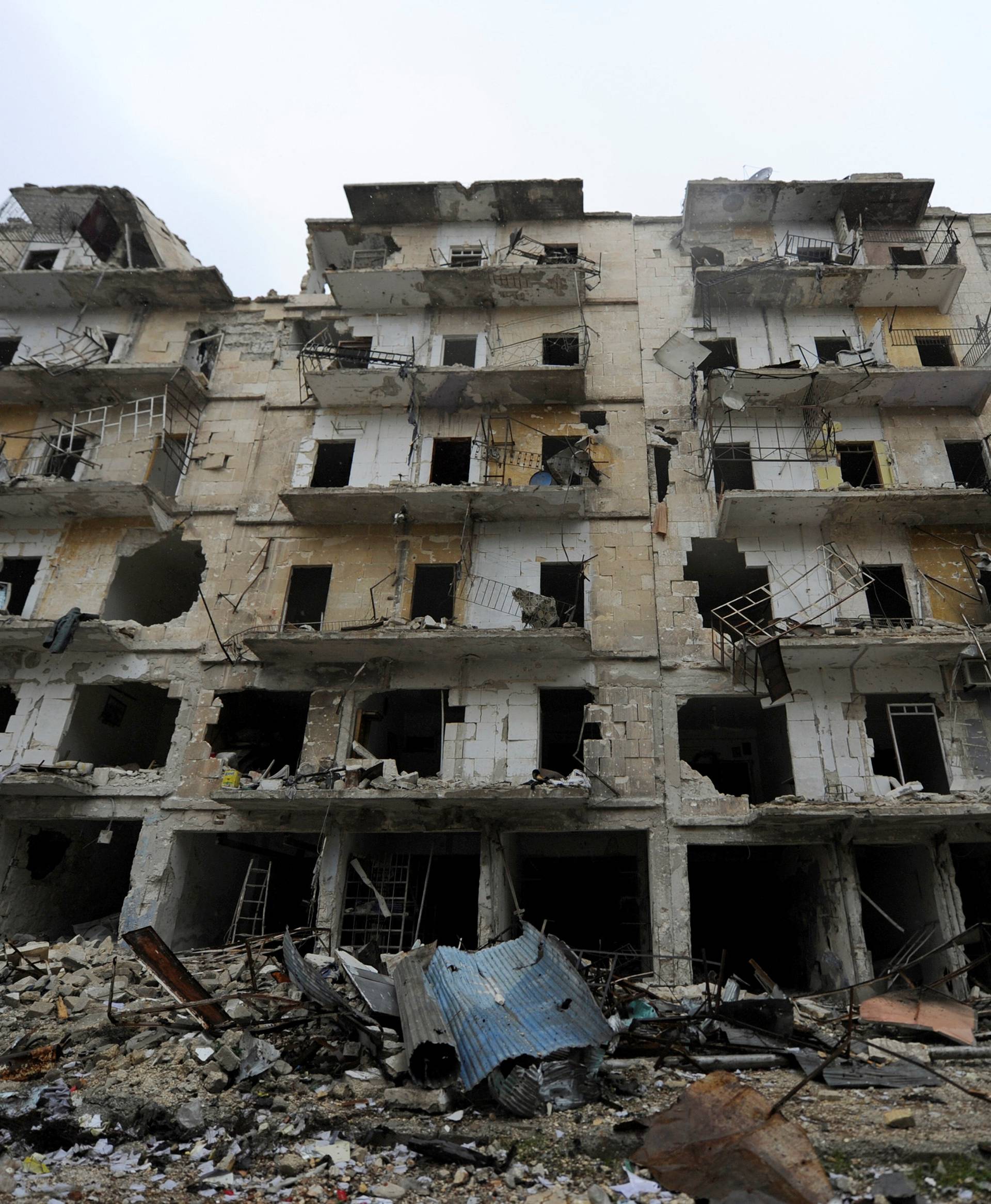 Damaged buildings are seen in the government-held al-Shaar neighborhood of Aleppo