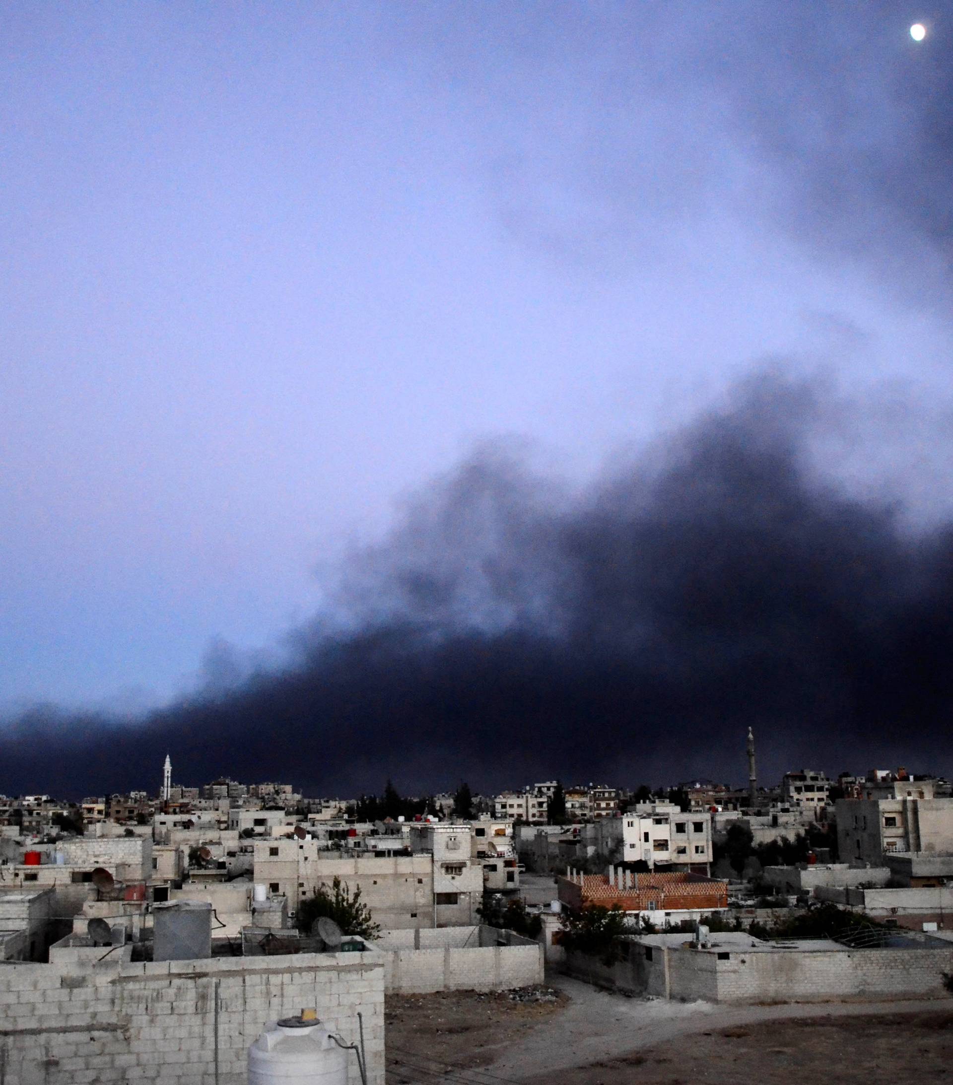 FILE PHOTO: Smoke rises into the sky from what activists said was Free Syrian Army fighters destroying a tank that belonged to forces loyal to Syria's President Bashar al-Assad in the Qaboun area, Eastern Ghouta