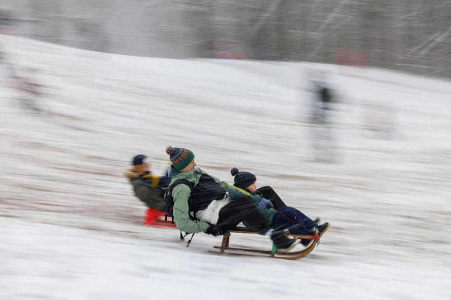 People sledge in Maksimir Park covered with snow in Zagreb