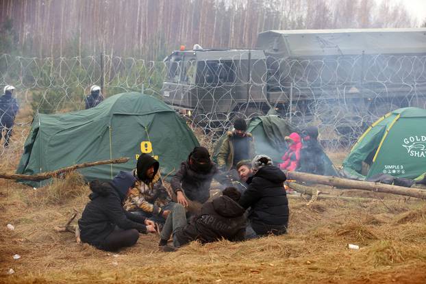 Migrants gather on the Belarusian-Polish border