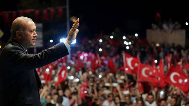 Handout photo of Turkish President Erdogan greeting his supporters outside of his residence in Istanbul