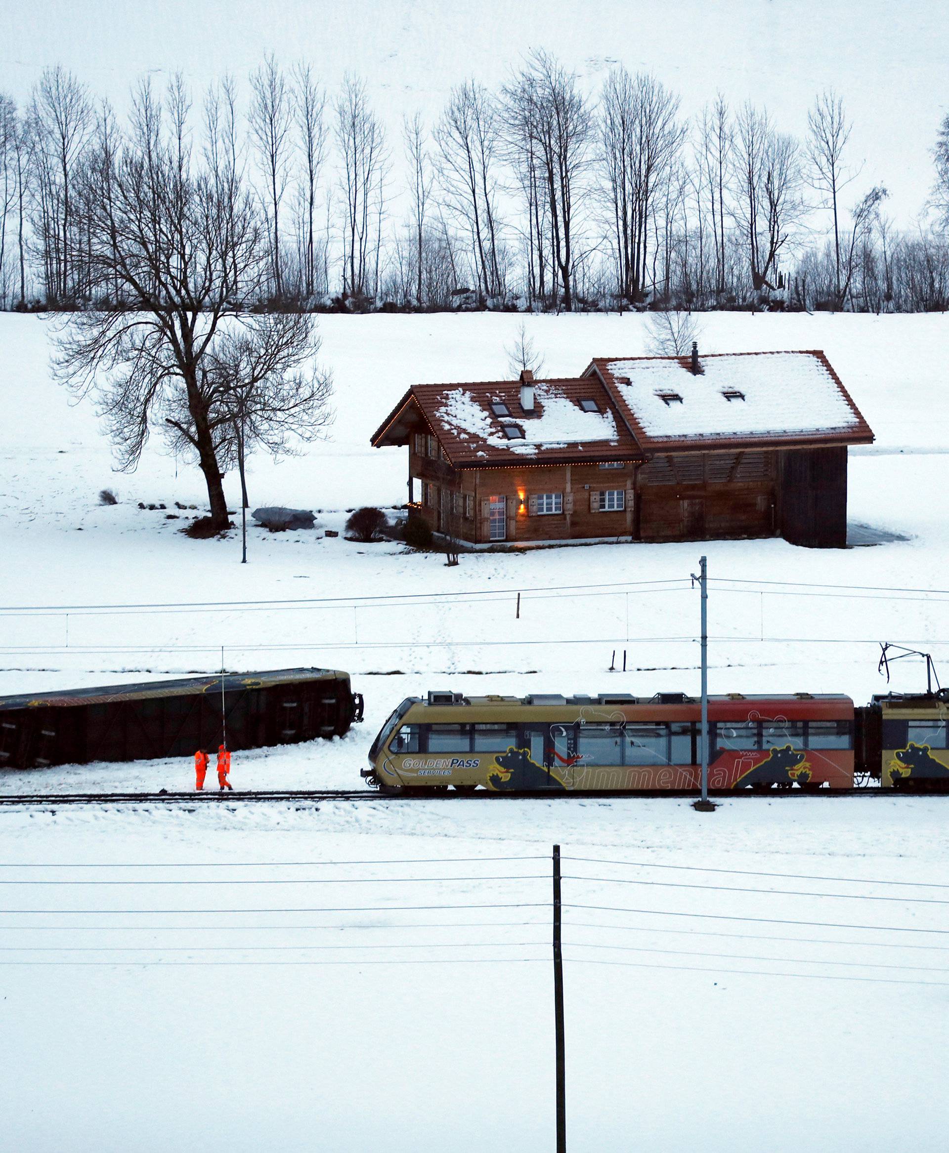 A carriage of the MOB train is pictured lying on its side after if was pushed out of the tracks by gusts of wind during storm Eleanor near Lenk
