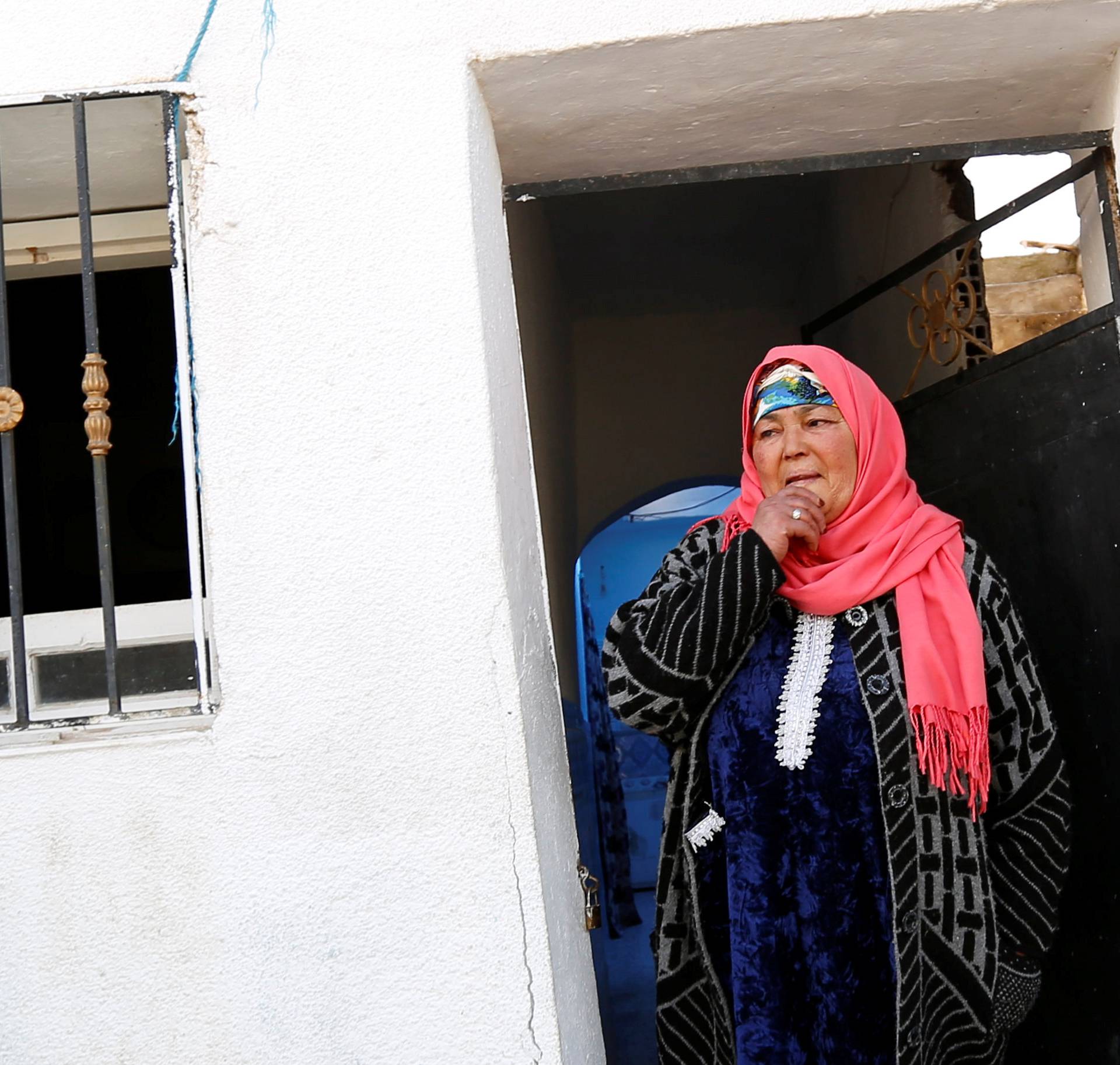 Nour, mother of suspect Anis Amri who is sought in relation with the truck attack on a Christmas market in Berlin, reacts near their home in Oueslatia, Tunisia