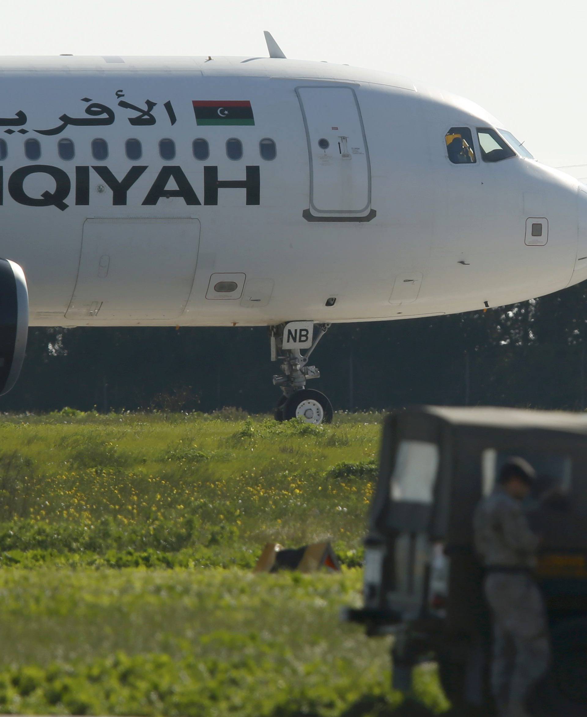 Maltese troops survey a hijacked Libyan Afriqiyah Airways Airbus A320 on the runway at Malta Airport