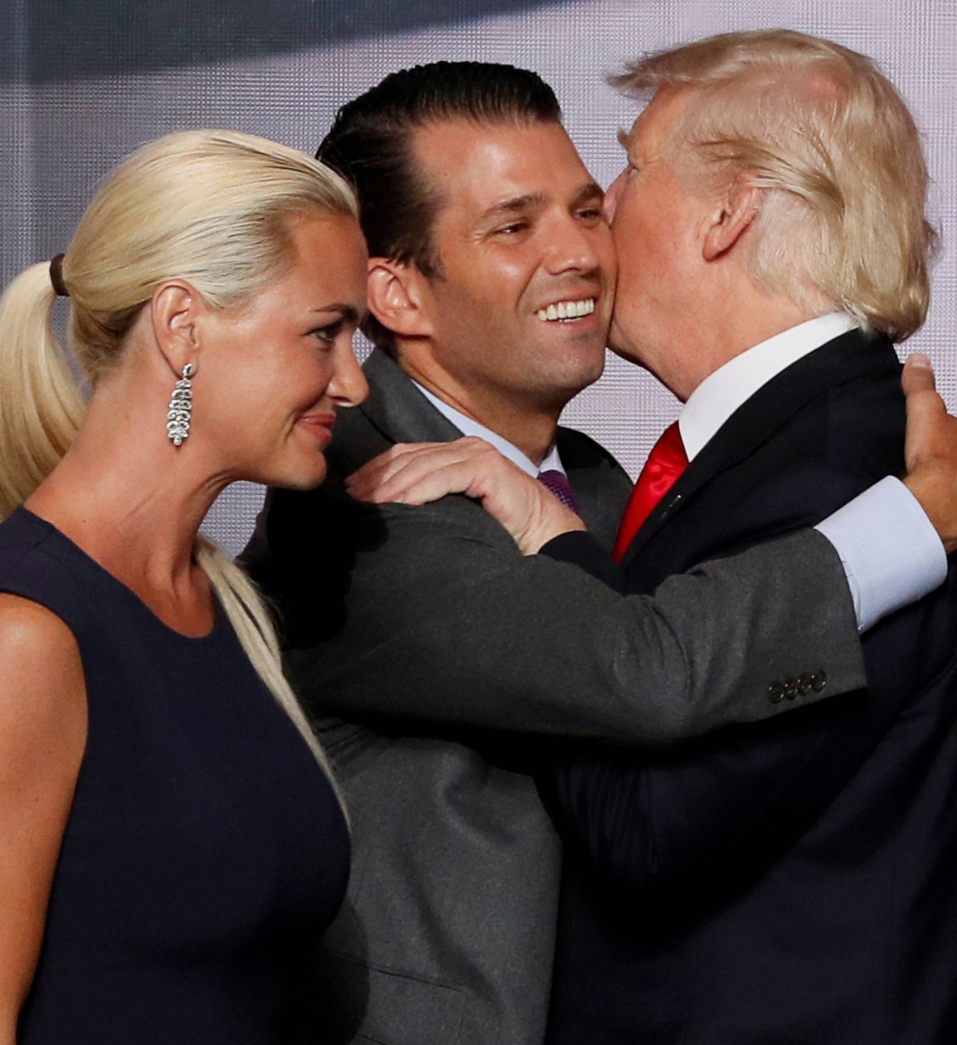 FILE PHOTO: Donald Trump Jr. hugs his father as his wife Vanessa walks past at 2016 Republican National Convention in Cleveland