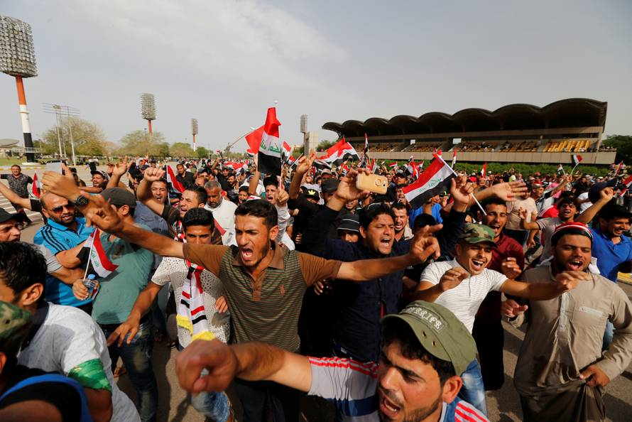 Followers of Iraq's Shi'ite cleric Moqtada al-Sadr shout slogans at Grand Festivities Square within the Green Zone in Baghdad