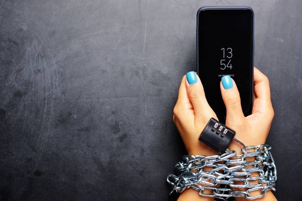 Woman,Hands,Tied,With,Metallic,Chain,With,Padlock,On,Dark