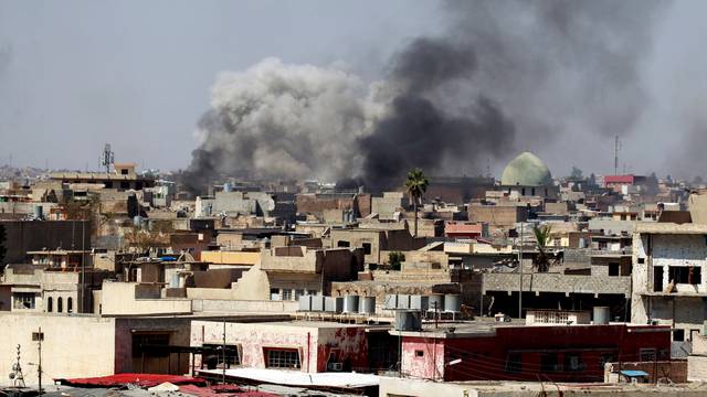 Smoke rises over the city during clashes between Iraqi forces and Islamic State militants, in Mosul