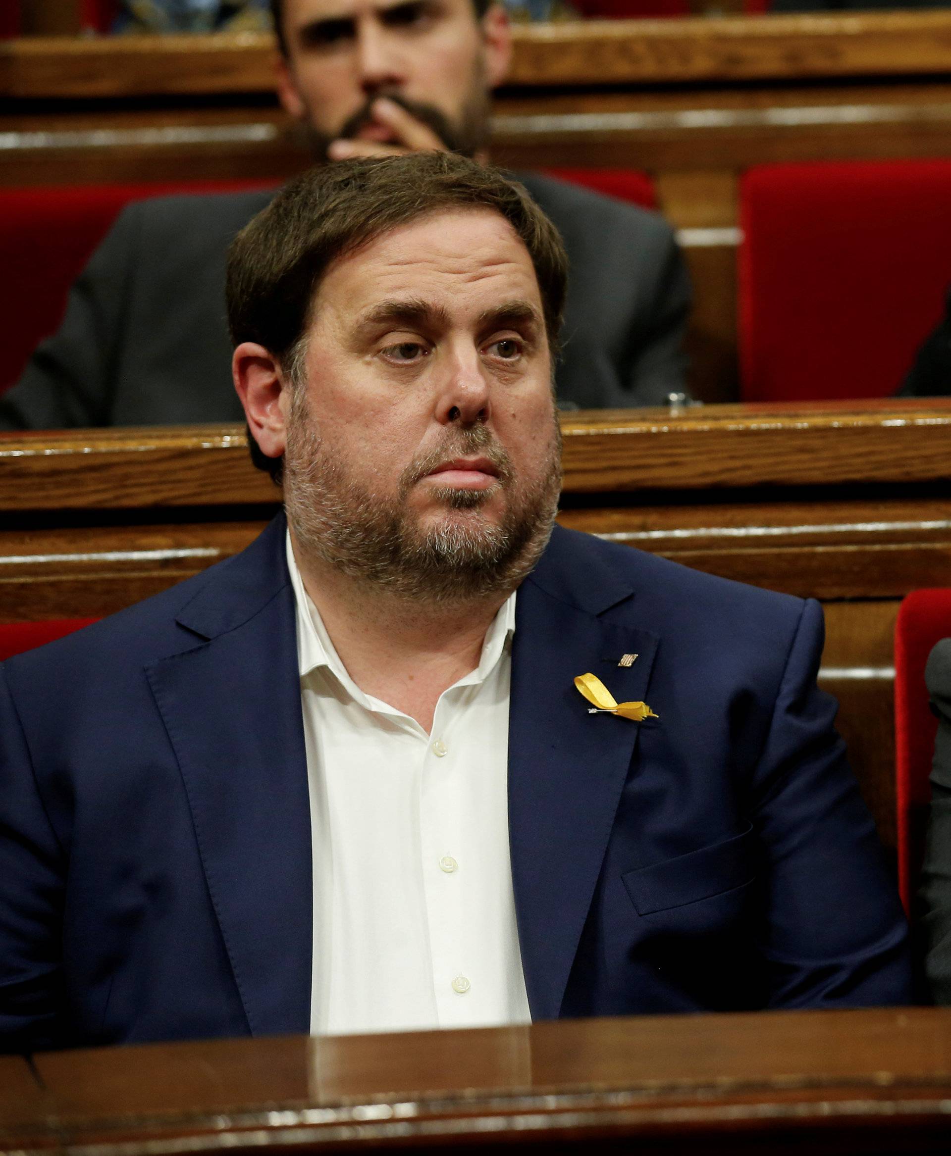 FILE PHOTO: Catalan President Puigdemont talks to Catalan Vice President Junqueras at the start of a session at the Catalan regional Parliament in Barcelona