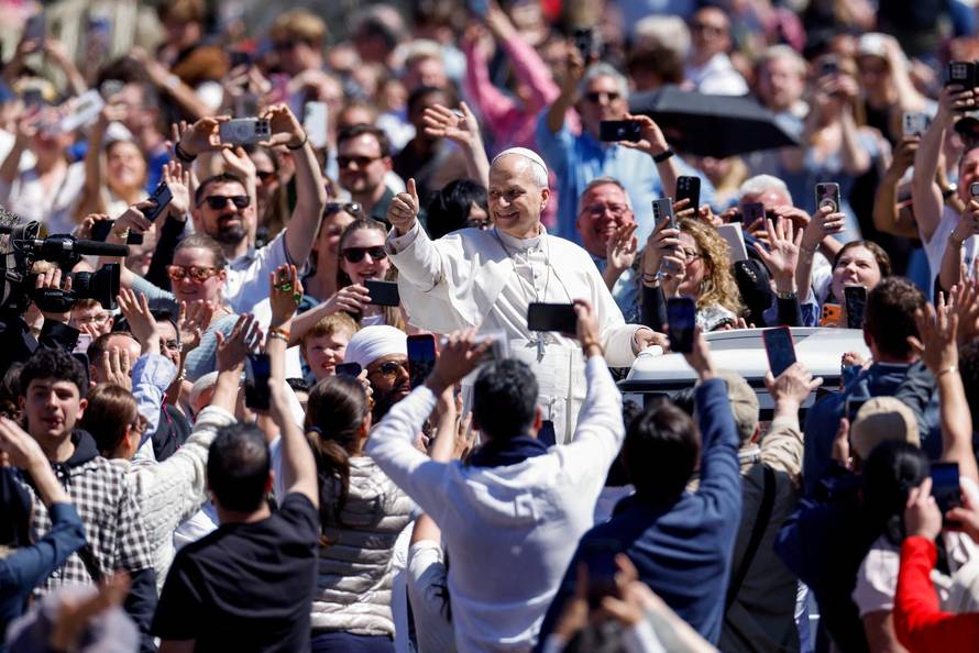 Pope Leo XIV delivers his "Urbi et Orbi" (To the city and the world) message from the main balcony of St. Peter's Basilica