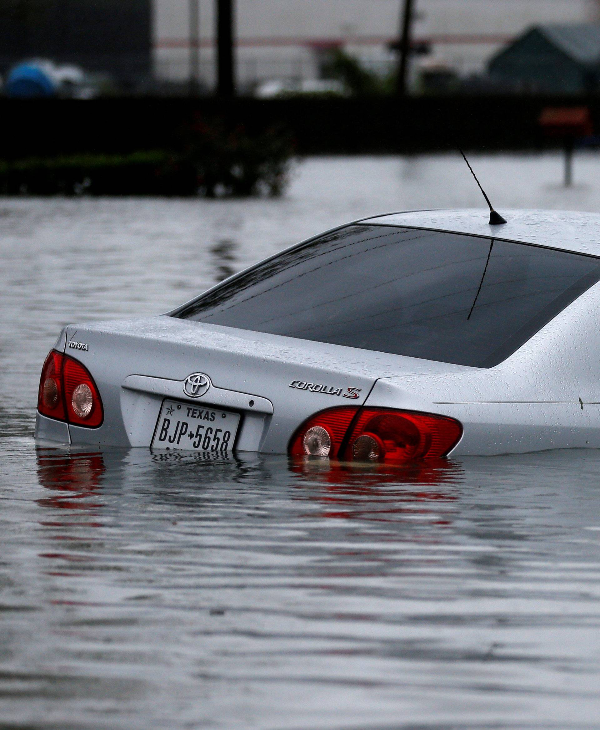 A car is seen submerged by flood waters from Tropical Storm Harvey in Orange