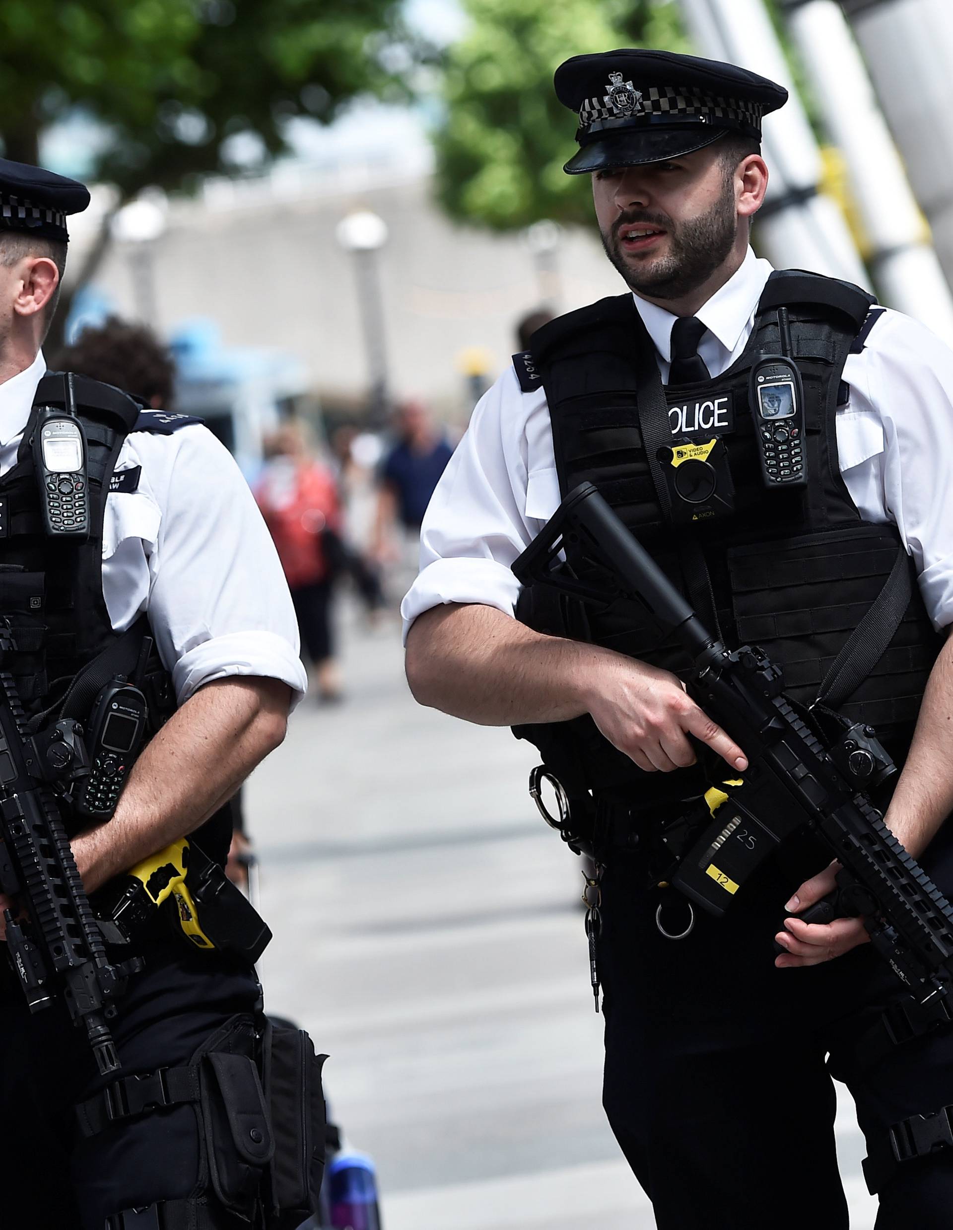 Armed police officers walk along the South Bank in London