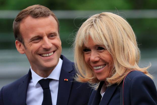 French President Emmanuel Macron and his wife Brigitte Macron arrive at the French national football team training center in Clairefontaine near Paris