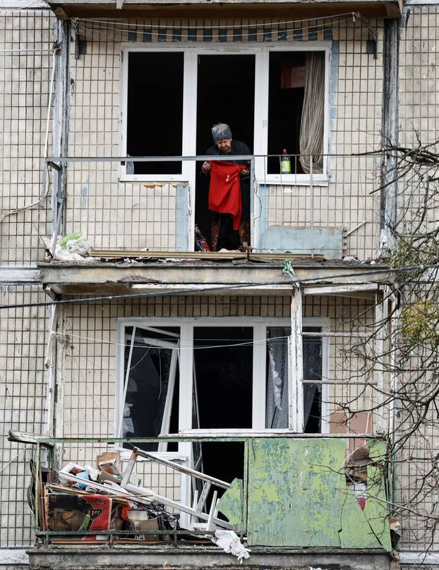 Emergency responders work at the site of a Russian drone strike on an apartment building, in Kyiv