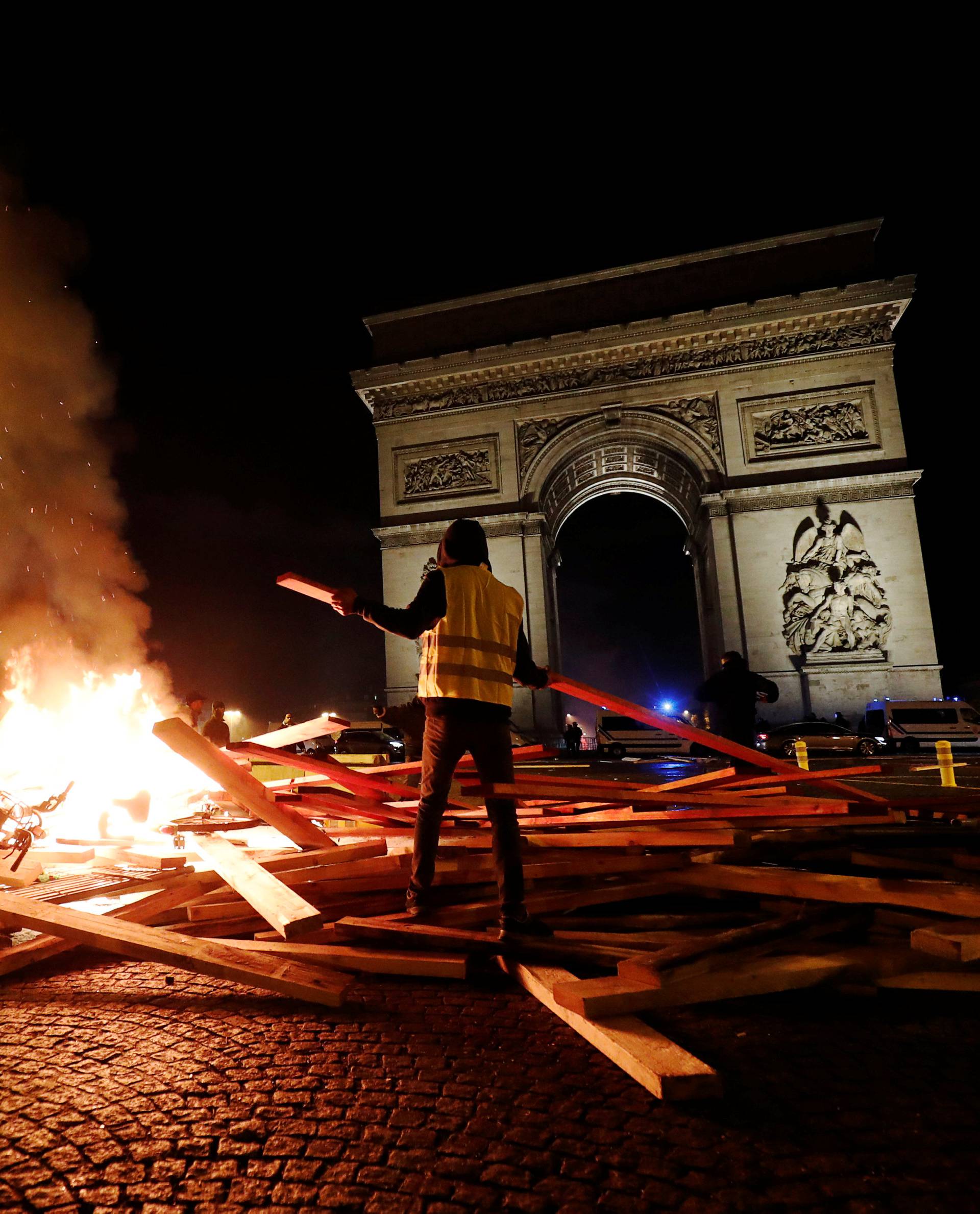 Protesters set fire during a "Yellow vest"Â protestsÂ against higher fuel prices, on the Champs-Elysees in Paris