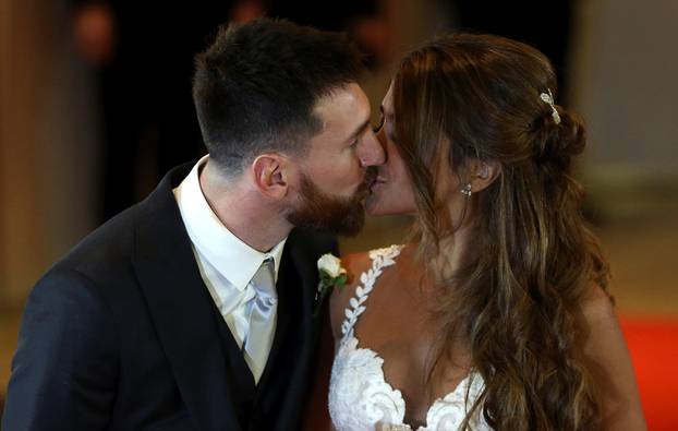 Argentine soccer player Lionel Messi and his wife Antonela Roccuzzo kiss as they pose at their wedding in Rosario, Argentina