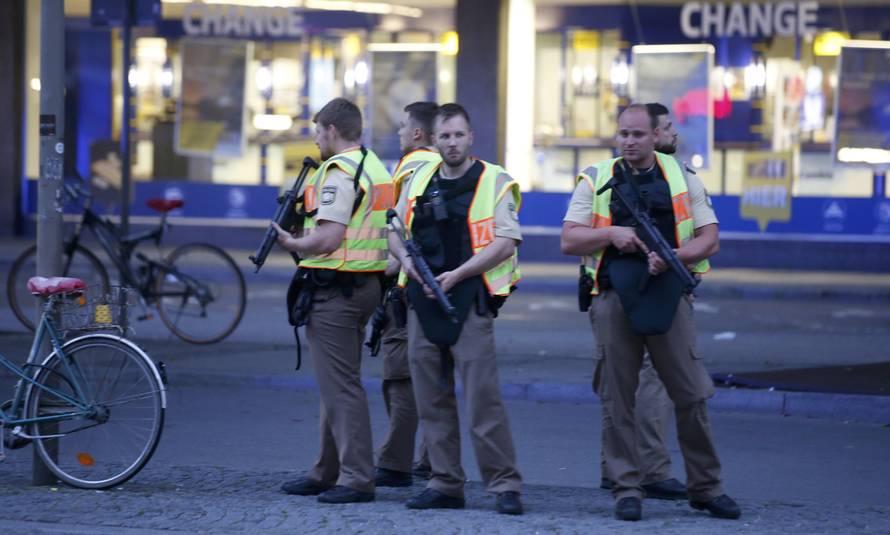 Police officers stand guard outside the main train station  following shooting rampage at shopping mall in Munich
