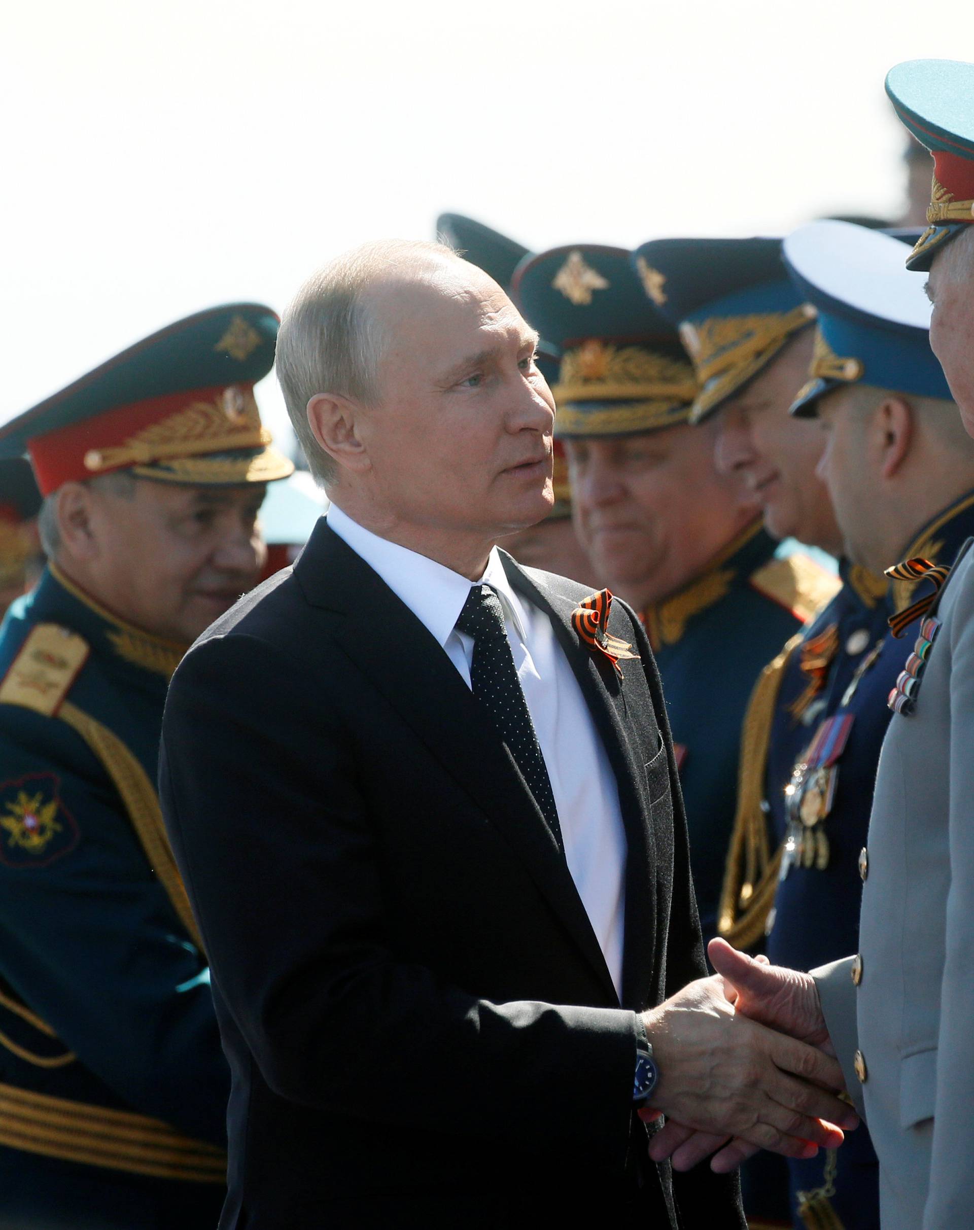 Russian President Vladimir Putin welcomes guests during the Victory Day parade at Red Square in Moscow