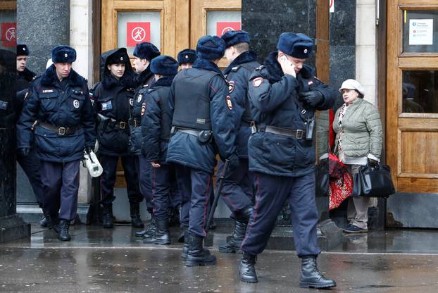 Police officers gather outside Ploschad Revolyutsii metro station in Moscow