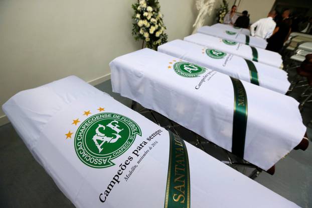 Blankets bearing the crest of Brazilian soccer team Chapecoense are placed on coffins holding the remains of the victims who died in an accident of the plane that crashed into the Colombian jungle with the team