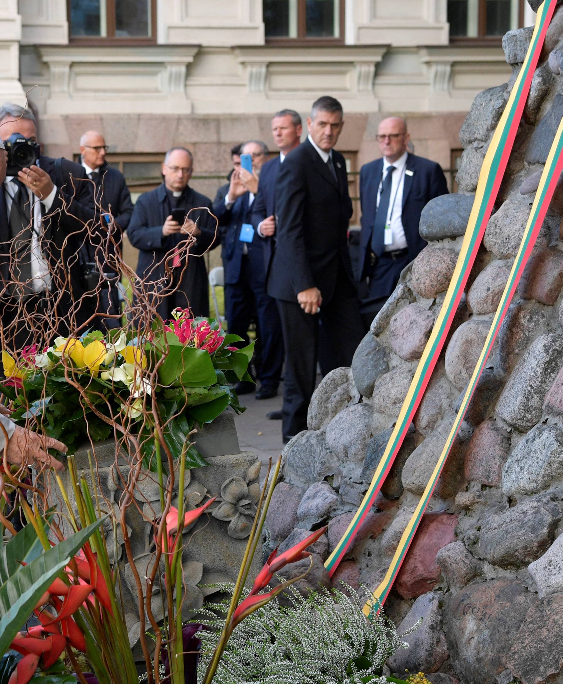 Pope Francis lays a wreath of flowers at a memorial outside the Museum of Occupations and Freedom Fights, in Vilnius