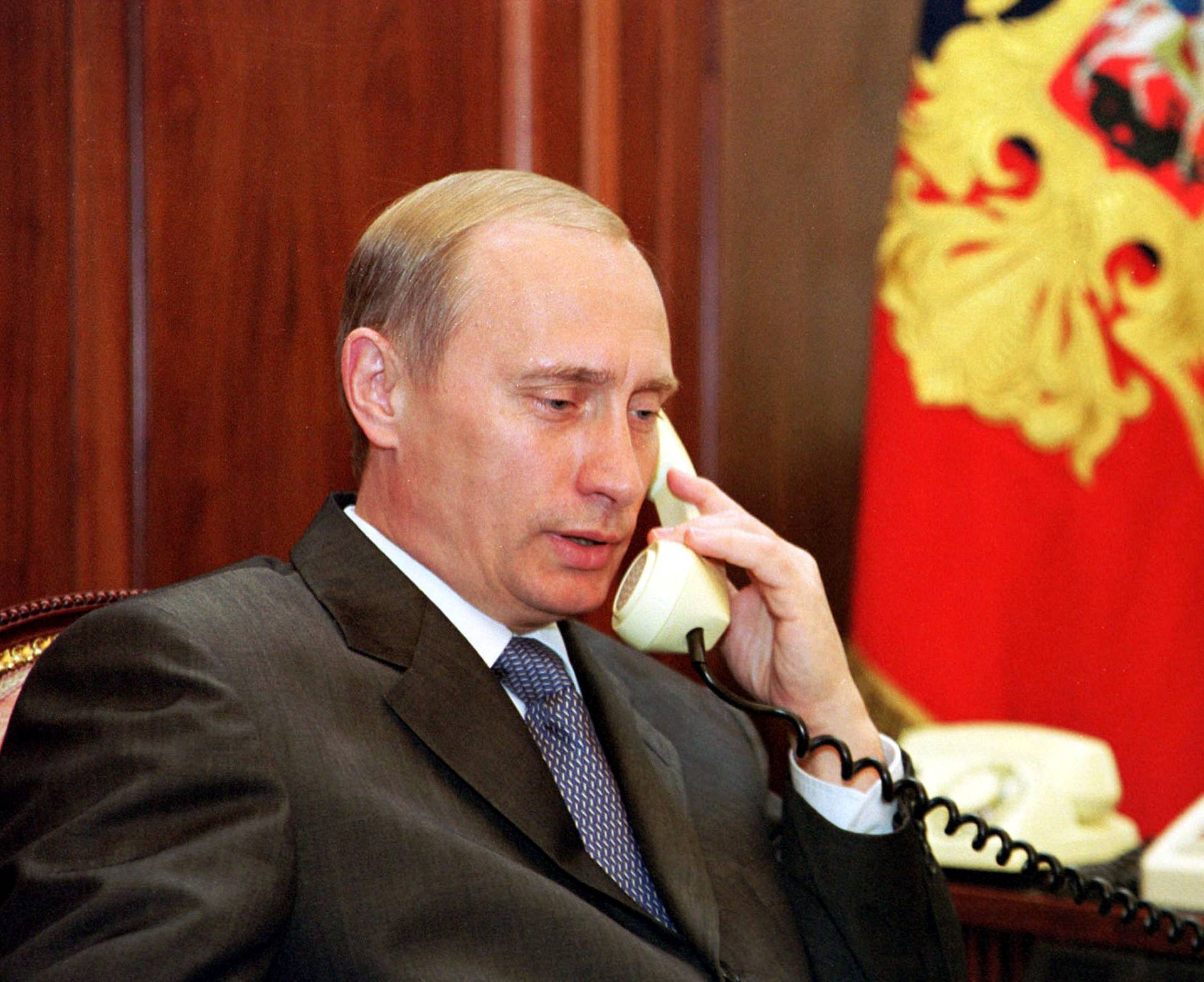 FILE PHOTO: Russian President Vladimir Putin speaks on the phone in his Kremlin office in Moscow