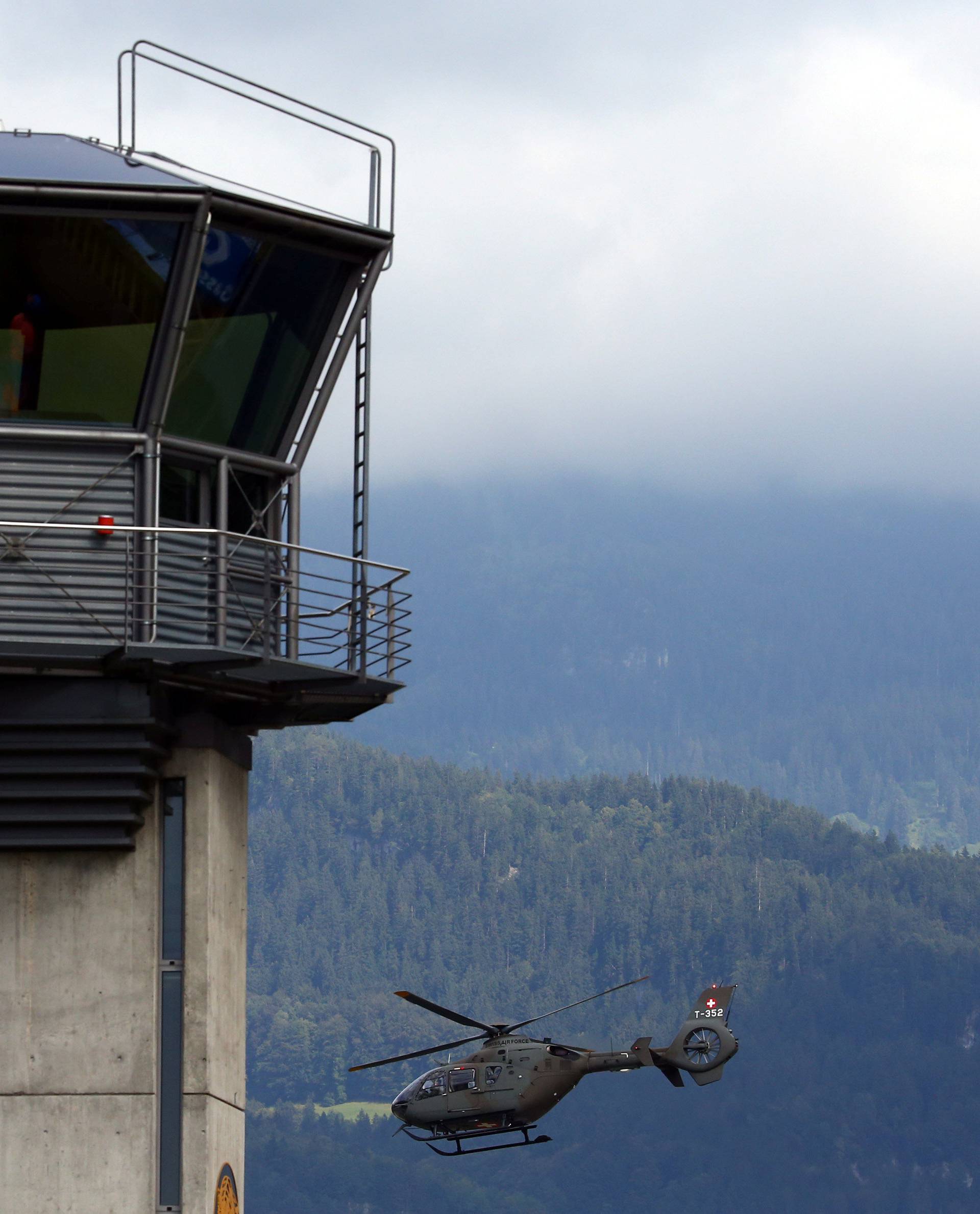 A Swiss Army Airforce helicopter take off next to the tower at the military airport in Meiringen