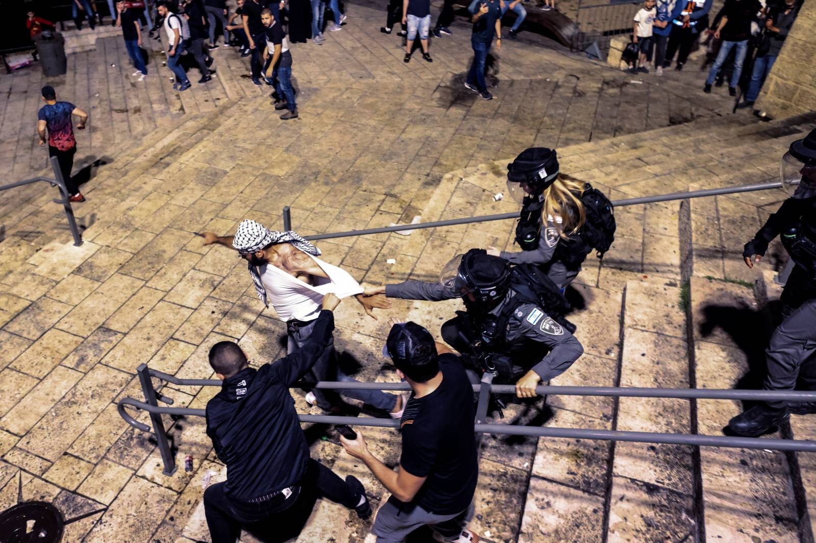 Israeli Border Police force detain a Palestinian protestor during clashes at Damascus Gate by the entrance to Jerusalem's Old City