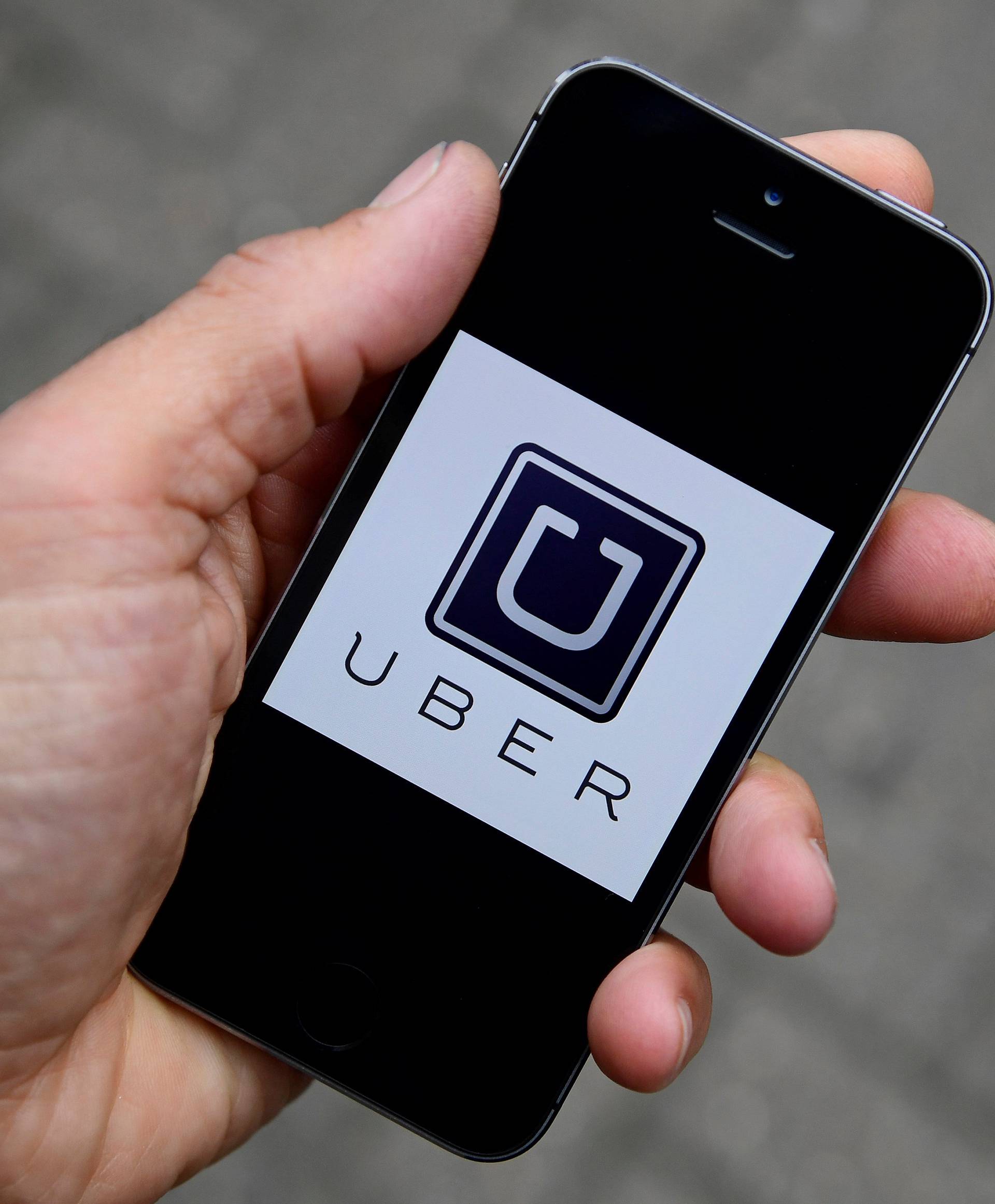 FILE PHOTO: The Uber app logo is seen on a mobile telephone