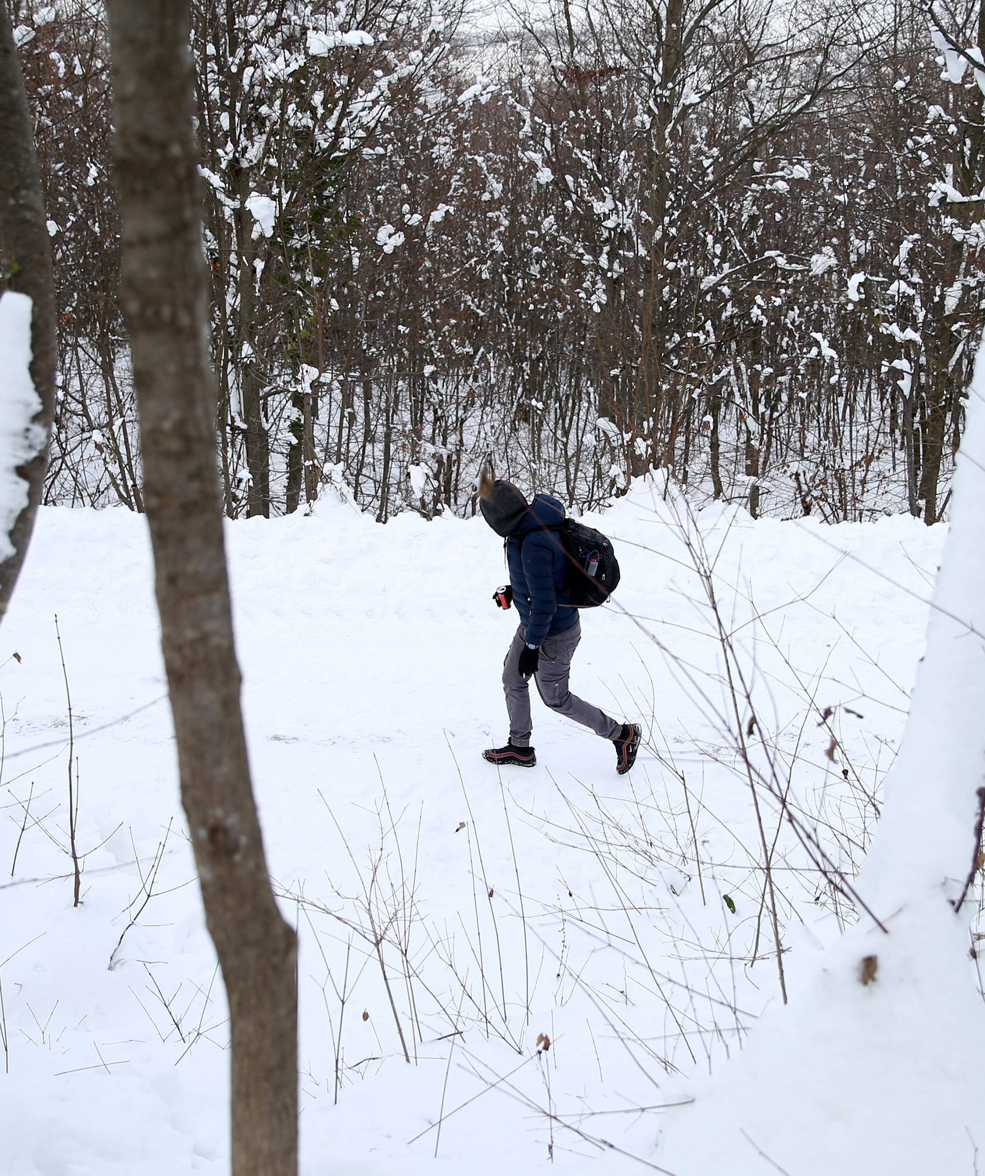 A migrant attempts to illegally cross the border into Croatia on the Pljesevica Mountain near Bihac
