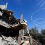 Israel aircrafts leave trails near the ruins of houses destroyed in Israeli strikes during the conflict, during a temporary truce between Hamas and Israel, in Khan Younis in the southern Gaza Strip