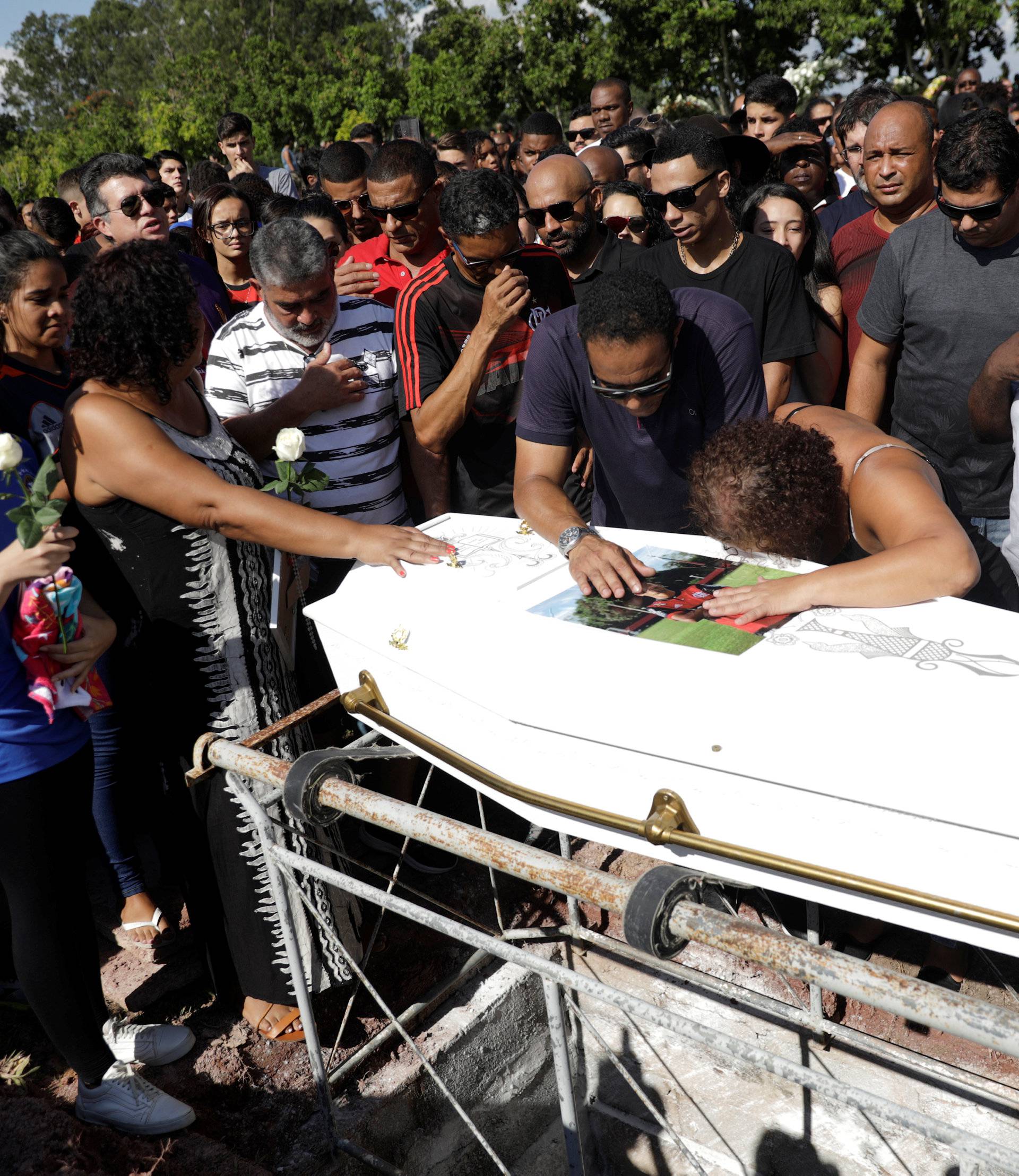 Relatives and friends of soccer player Vinicius de Barros Silva Freitas attend his burial, after a deadly fire at Flamengo soccer club's training center, in Volta Redonda