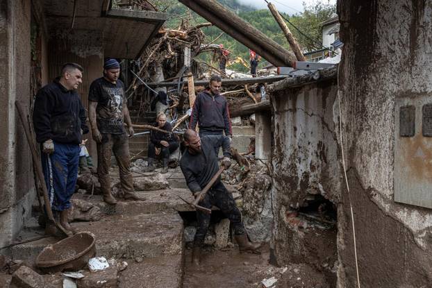 People search for victims following a landslide in the flooded village of Donja Jablanica