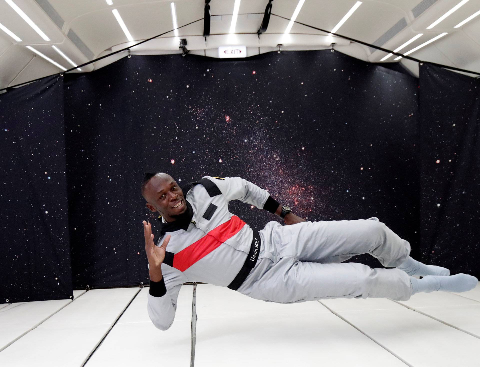 Retired sprinter Usain Bolt poses as he enjoys zero gravity conditions during a flight in a specially modified plane above Reims