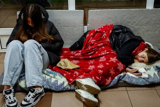 People take shelter inside a metro station during a Russian military attack, in Kyiv