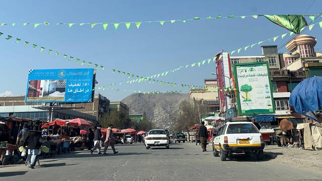 Flags strung up on a street ahead of the Persian New Year or Nowruz festival in Kabul