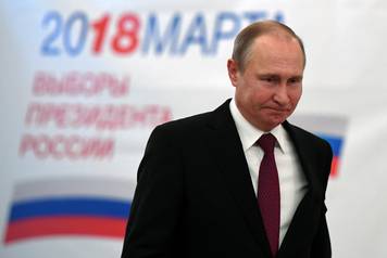Russian President and Presidential candidate Vladimir Putin at a polling station during the presidential election in Moscow