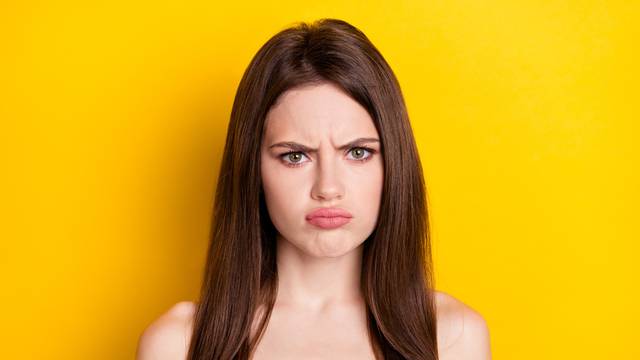 Photo of sad brunette lady wear pink shirt isolated on yellow color background