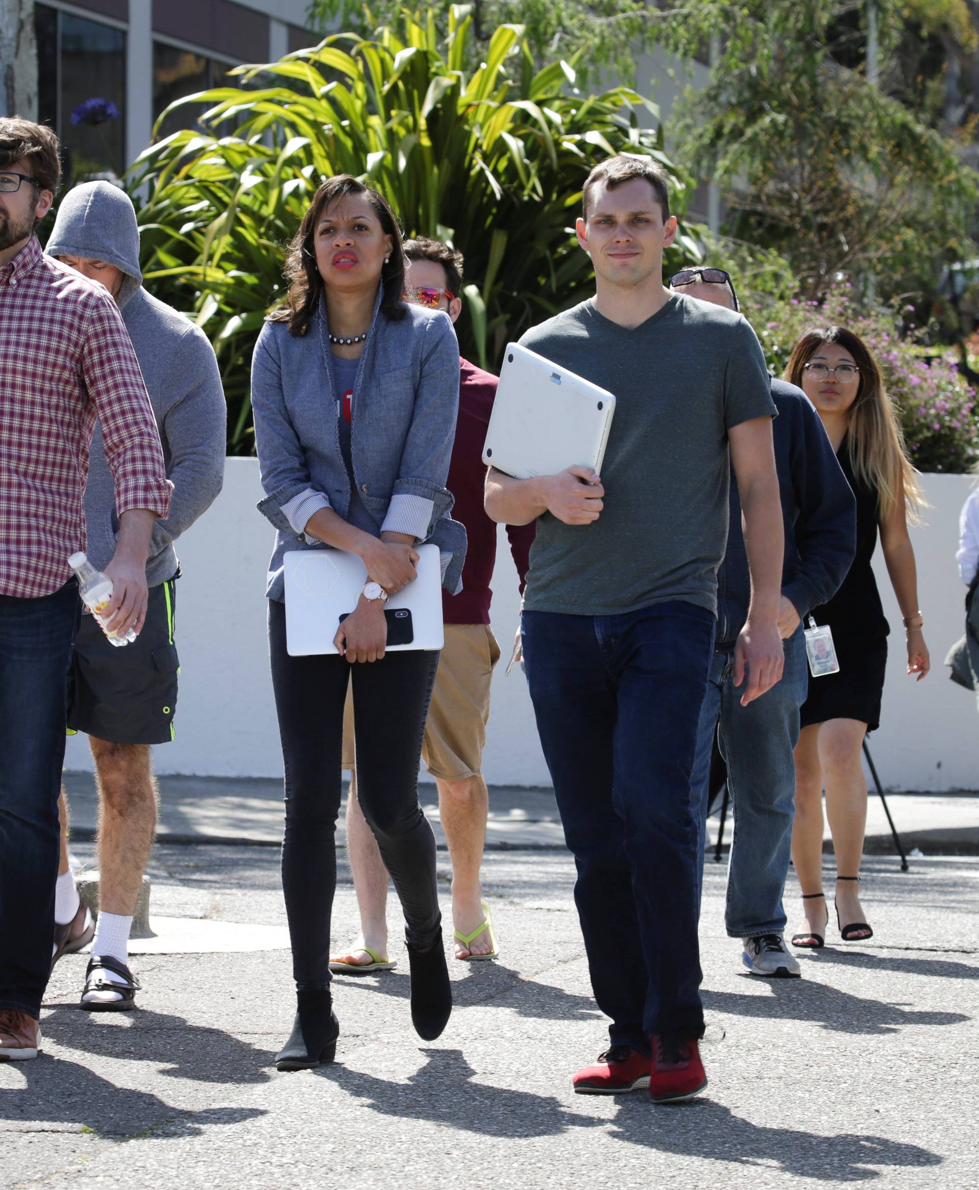 YouTube employees are seen walking away from Youtube headquarters following an active shooter situation in San Bruno, California