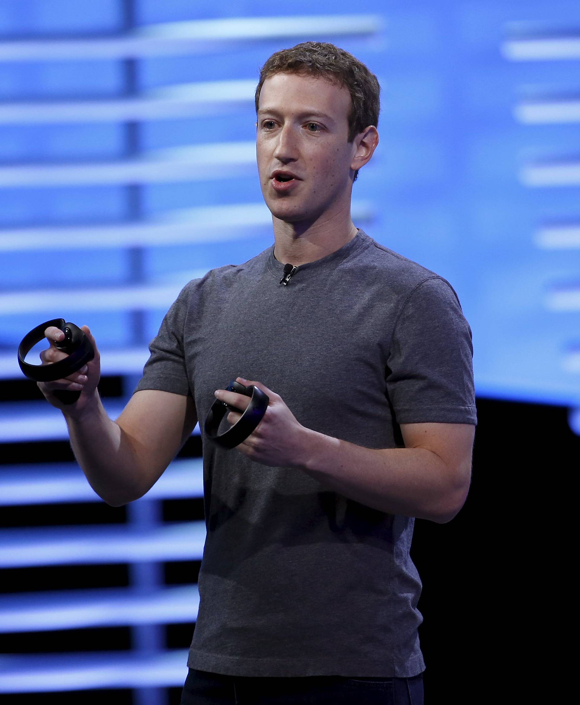 Facebook CEO Mark Zuckerberg holds a pair of the touch controllers for the Oculus Rift virtual reality headsets during the Facebook F8 conference in San Francisco, California