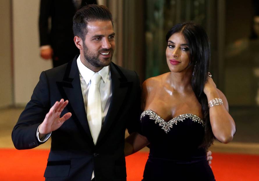 Argentine soccer player Lionel Messi's former Barcelona FC teammate Cesc Fabregas and his wife Daniella Semaan pose for photographers as they arrive to the wedding of Messi and Antonela Roccuzzo in Rosario