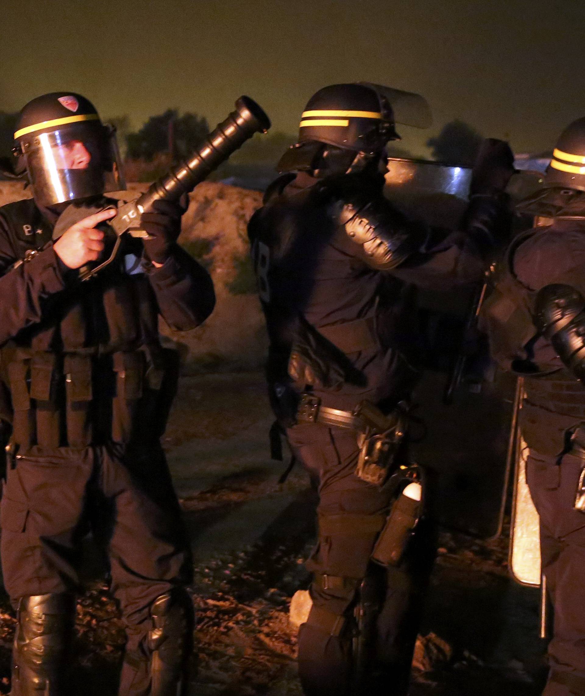 French CRS riot police secure an area on the eve of the evacuation and transfer of migrants to reception centers in France, and the dismantlement of the camp called the "Jungle" in Calais