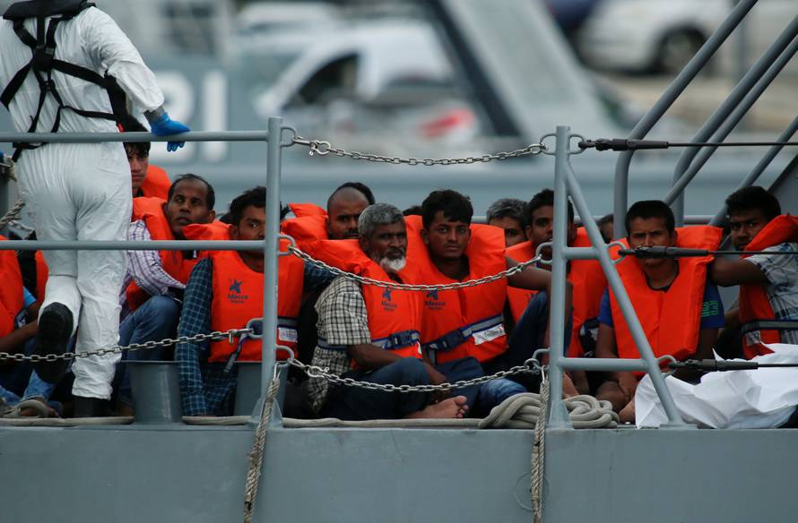 Rescued migrants are seen on board of a patrol boat as they enter Marsamxett Harbour, Valletta